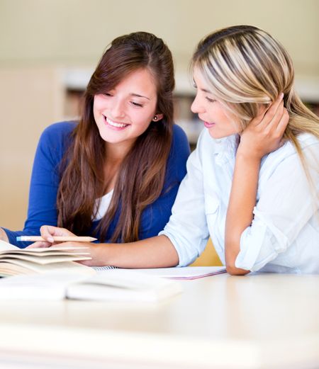 Young women studying together at the library