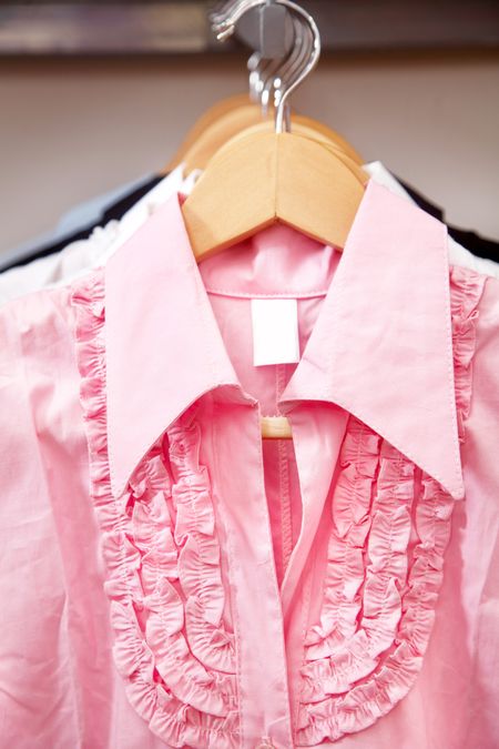 pink blouse hanging in a retail store