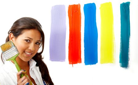 female artist choosing colours to paint the wall - isolated over a white background