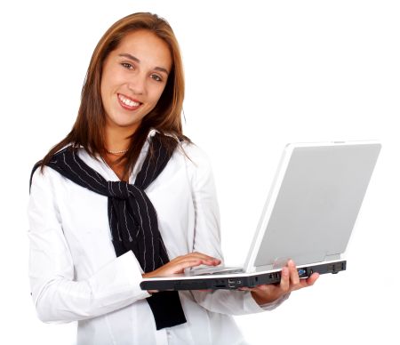 Business woman typing on a laptop computer - isolated over a white background