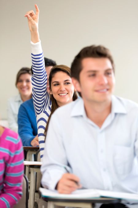 Female student participating in class raising her hand