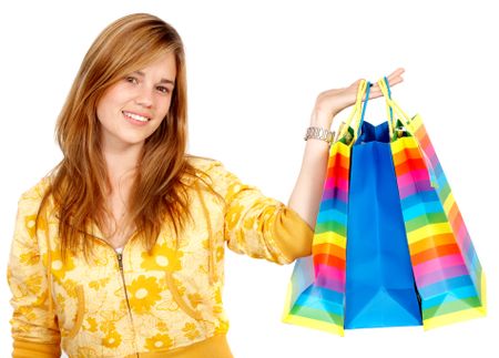 girl smiling carrying shopping bags isolated over a white background