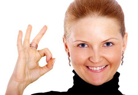 business woman full of success doing the ok sign with her hand isolated over a white background