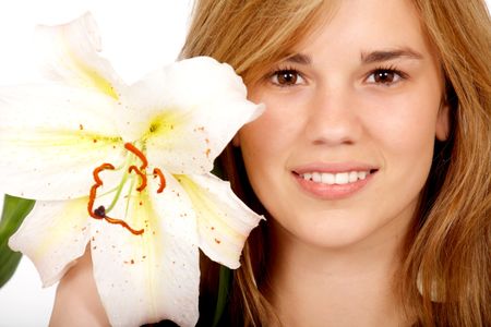 healthy blond girl smiling portrait holding a flower next to her face - isolated over a white background
