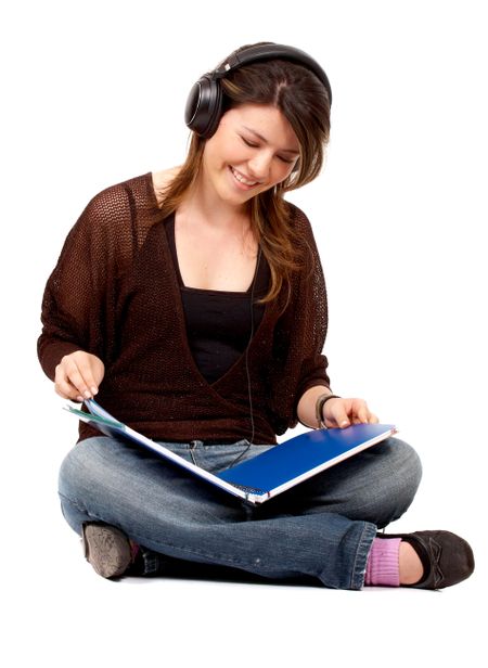 college student listening to music while styduing - isolated over a white background