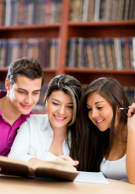 Group of students reading at the library