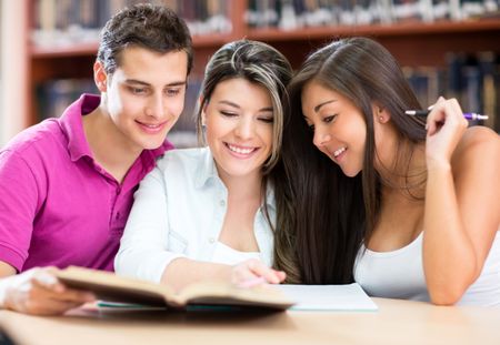 Group of students studying together at the library