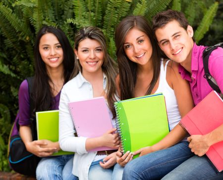 Happy group of students sitting outdoors and smiling