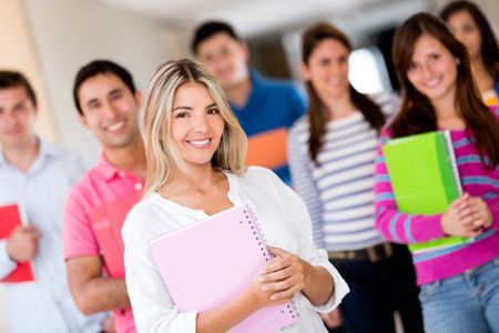 Female student with a group of friends looking happy