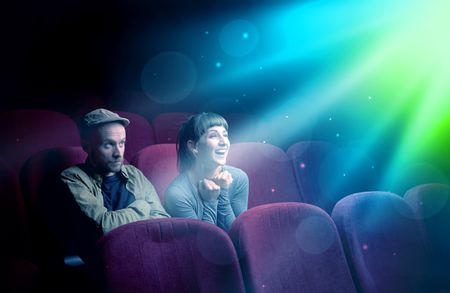 Teenager couple cuddling and watching the climax part of the movie