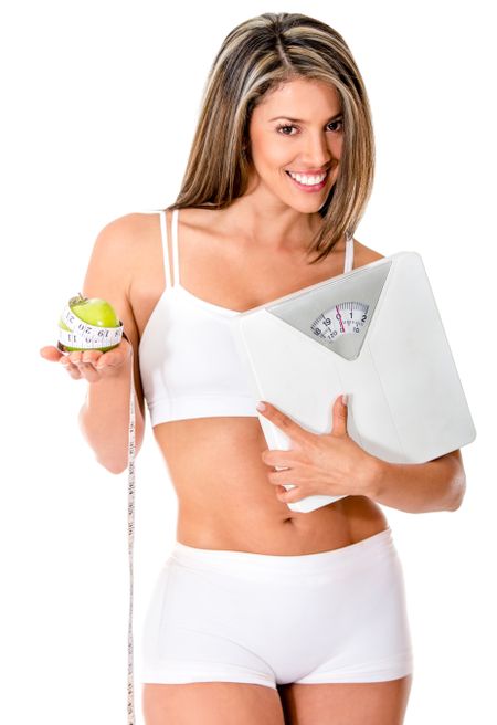 Woman on a diet holding a scale - isolated over a white background