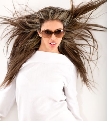 Fashion woman against the wind wearing sunglasses
