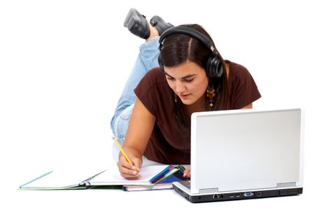 college girl studying with some notebooks and a laptop computer - isolated over a white background