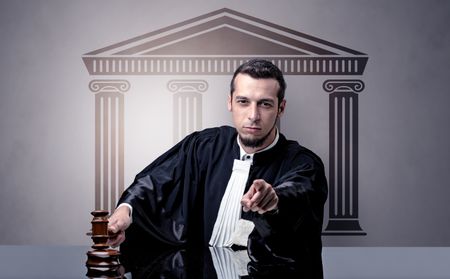 Young judge in front of a courthouse symbol making decision