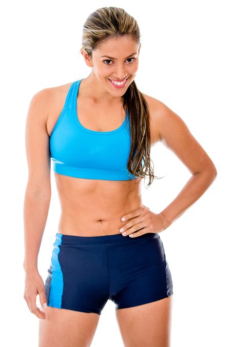 Fit female athlete smiling - isolated over a white background