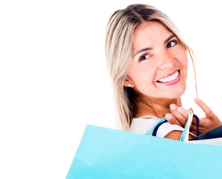 Thoughtful shopping woman smiling - isolated over a white background