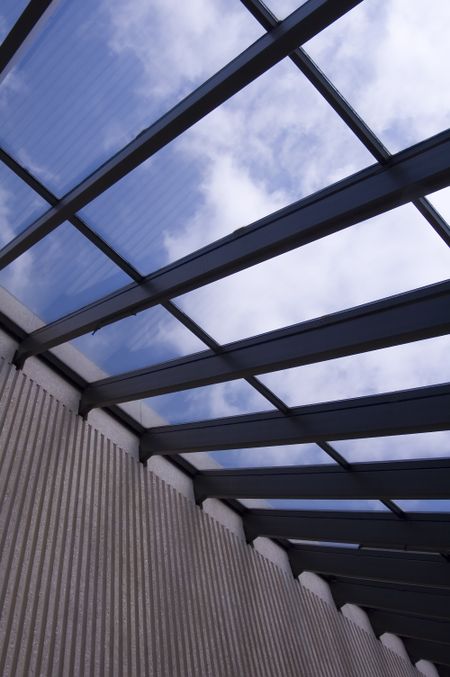 Section of a skylight with blue sky and clouds