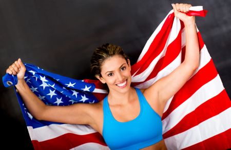 American female athlete proudly holding the USA flag