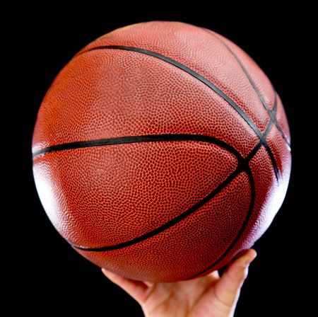 Basketball ball - isolated over a black background