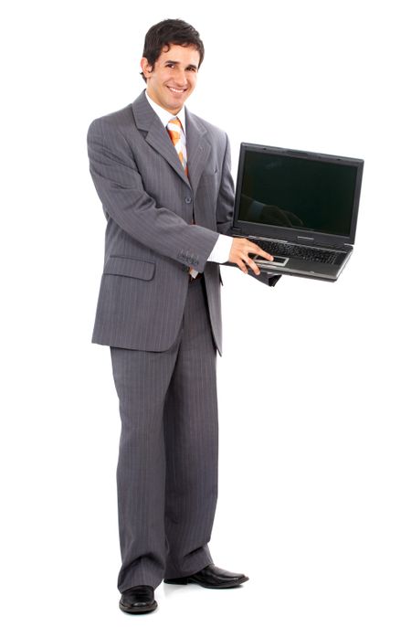 Business man standing and displaying a laptop computer - isolated over a white background