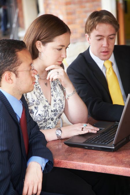 business team during a meeting in an office looking at a laptop computer