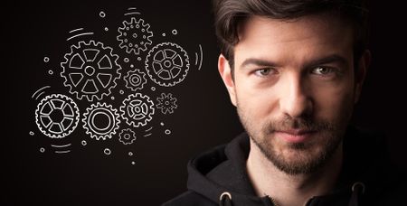 portrait-young-businessman-rotating-gears-next-1074450899 Portrait of a young businessman with rotating gears next to him on a dark background