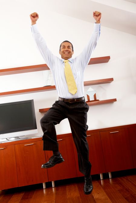 happy business man jumping in his office
