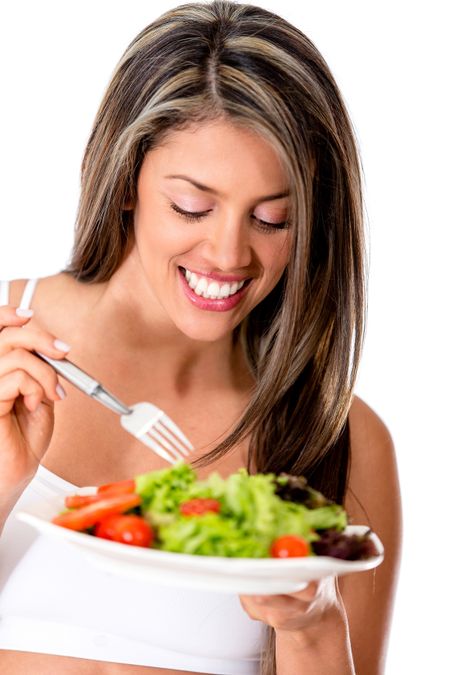 Woman eating a healthy salad - isolated over  white background
