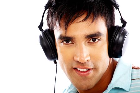 man looking happy listening to music on his headphones isolated over a white background