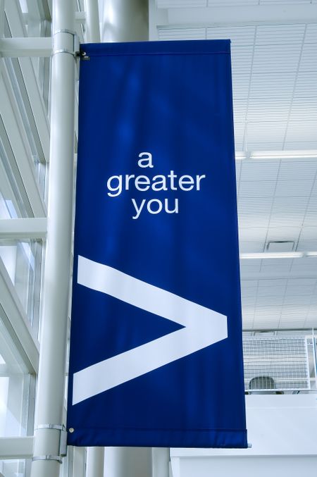 Banner in college hallway: "a greater you"