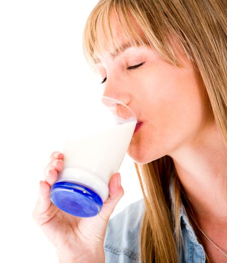 Woman drinking a glass of milk - isolated over a white background