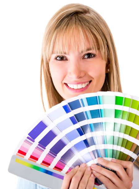 Happy woman selecting a color to paint the house - isolated over white