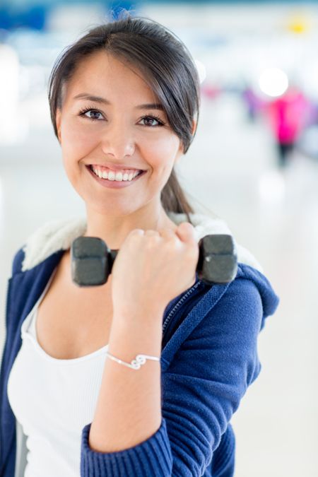 Woman working out and lifting a free weight