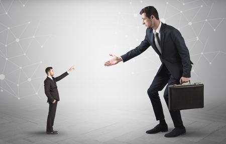 Small businessman aiming at a big businessman with connection and network concept
