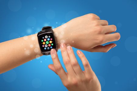 Naked female hand with smartwatch and with application icons on it