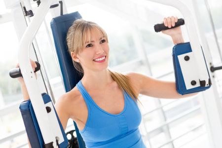 Woman working out at the gym on a machine