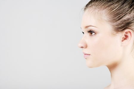 Young woman in a beauty style pose in profile