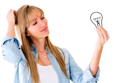Thoughtful woman having an idea and holding a bulb