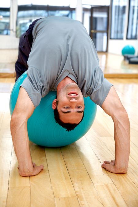 man doing pilates exercises in a gym