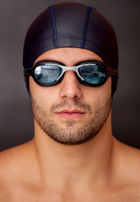 Professional male swimmer wearing goggles and a hat