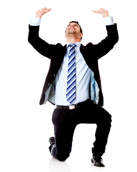 Businessman on his knees lifting something - isolated over a white backgorund