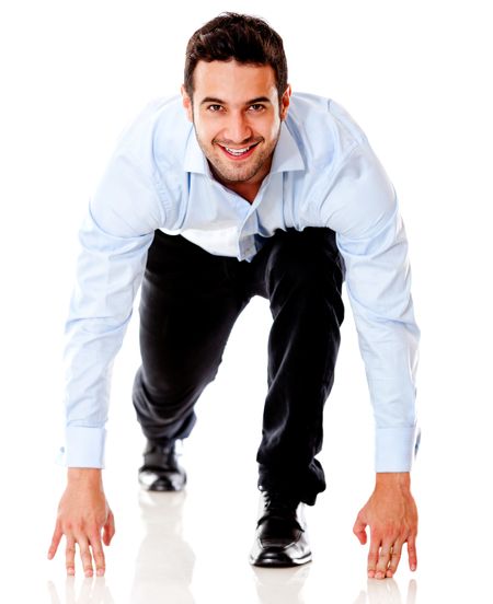 Businessman in position ready to run - isolated over white background