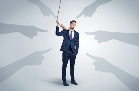 Young businessman trying to suicide with pointing hands concept