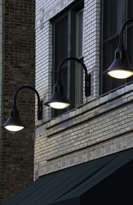 Three electric lights above awning of storefront