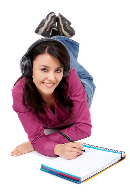 Casual student listening to music while studying isolated over a white background