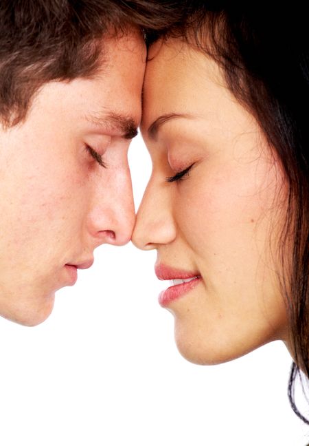 couple facing each other with their eyes closed isolated over a white background