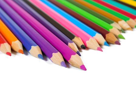 color pencils in a row over white