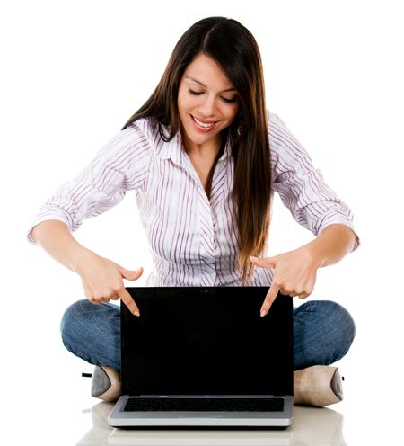 Woman pointing a laptop - isolated over a white background