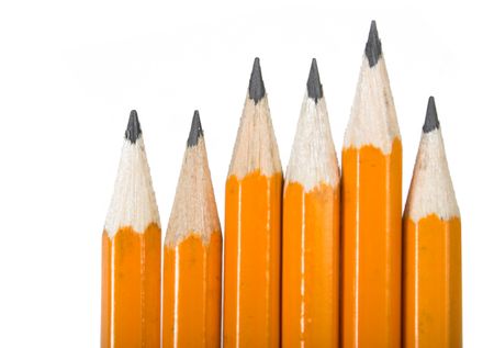 black pencils in a row over a white background