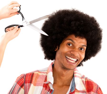 Afro man at the hairdresser getting a hair cut - isolated over white